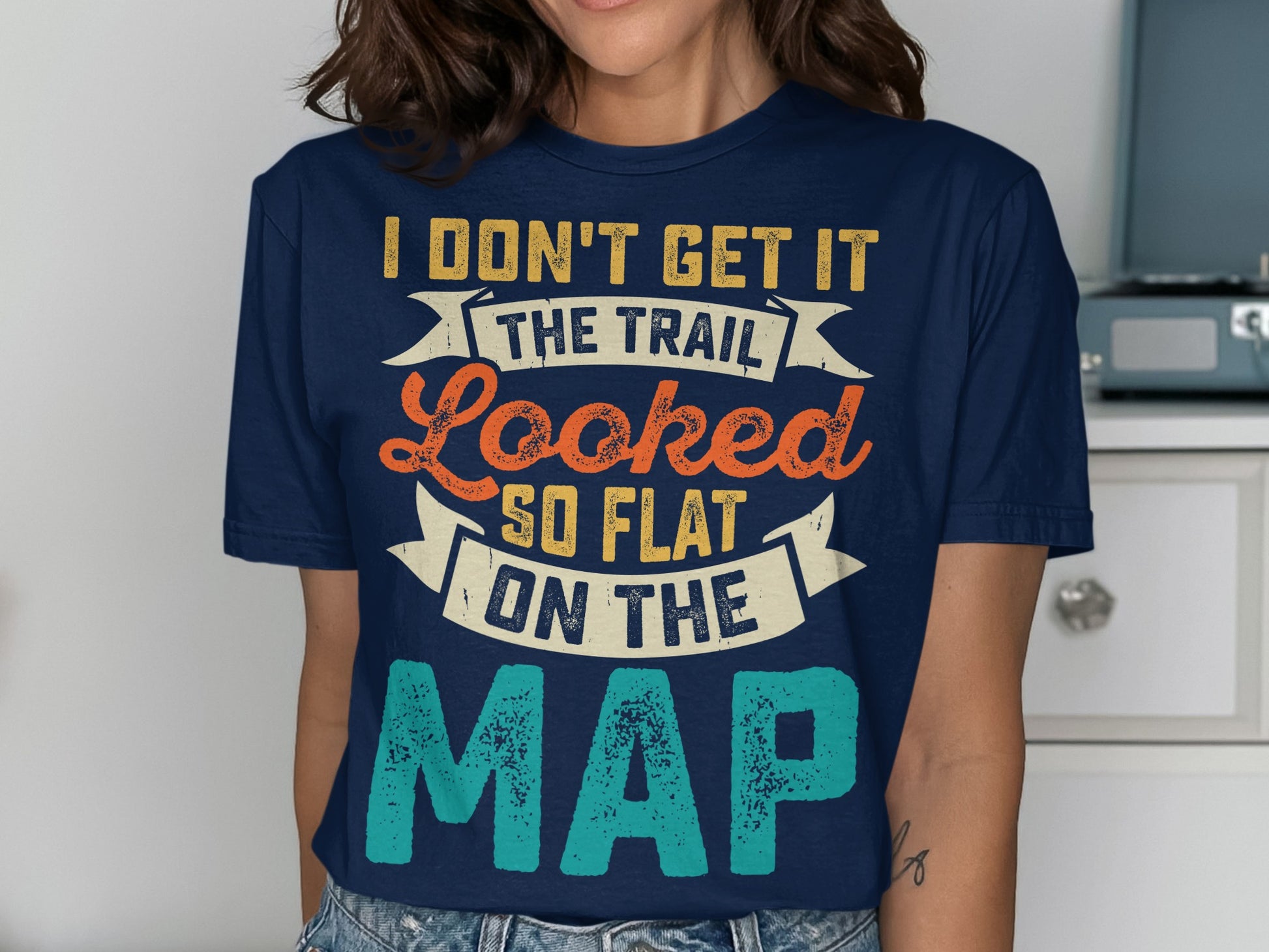 Navy t-shirt with "I don't get it the trail looked so flat on the map" text.