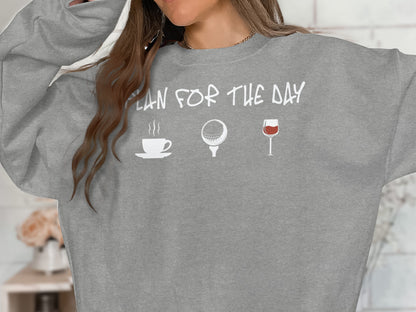 Gray sweatshirt with text "PLAN FOR THE DAY" and coffee, golf, and wine icons.