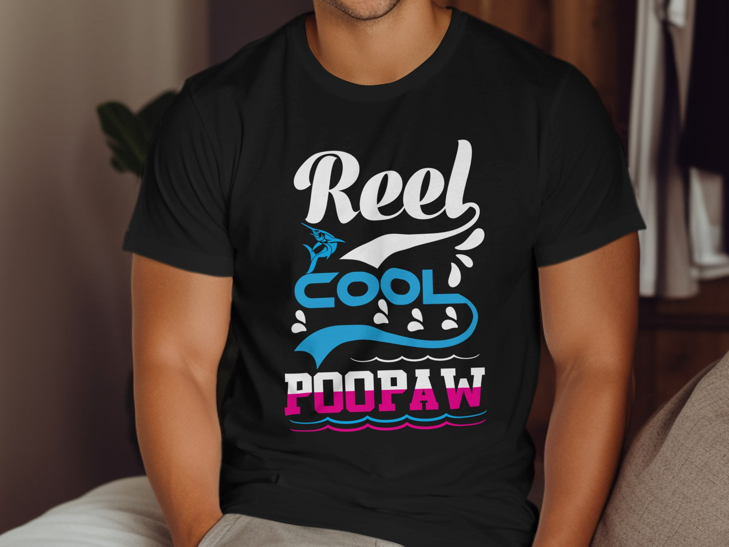 Black t-shirt with "Reel Cool Poopaw" text and fishing graphics.