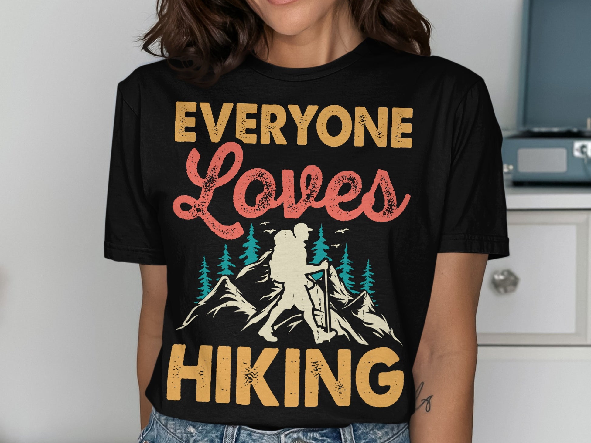 Black t-shirt with "EVERYONE Loves HIKING" text and mountain graphic.