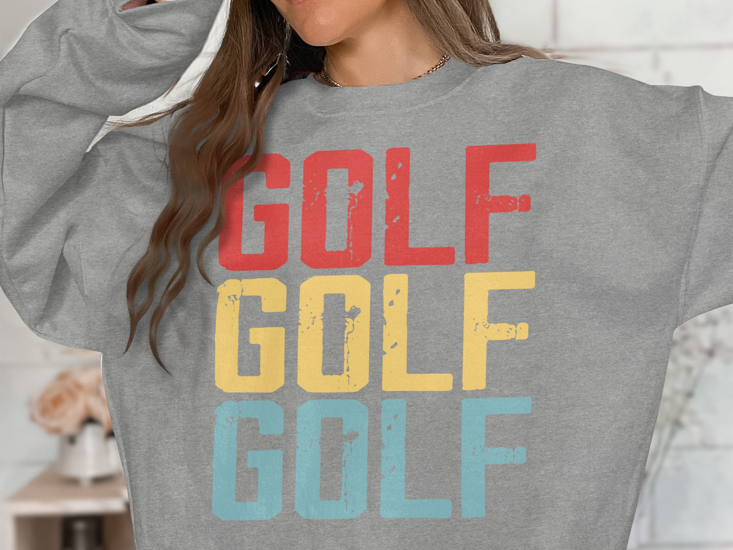 Grey sweatshirt with "GOLF" printed in red, yellow, and blue.