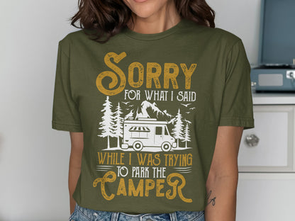 Olive green t-shirt with "Sorry for what I said while I was trying to park the camper" text and camper graphic.