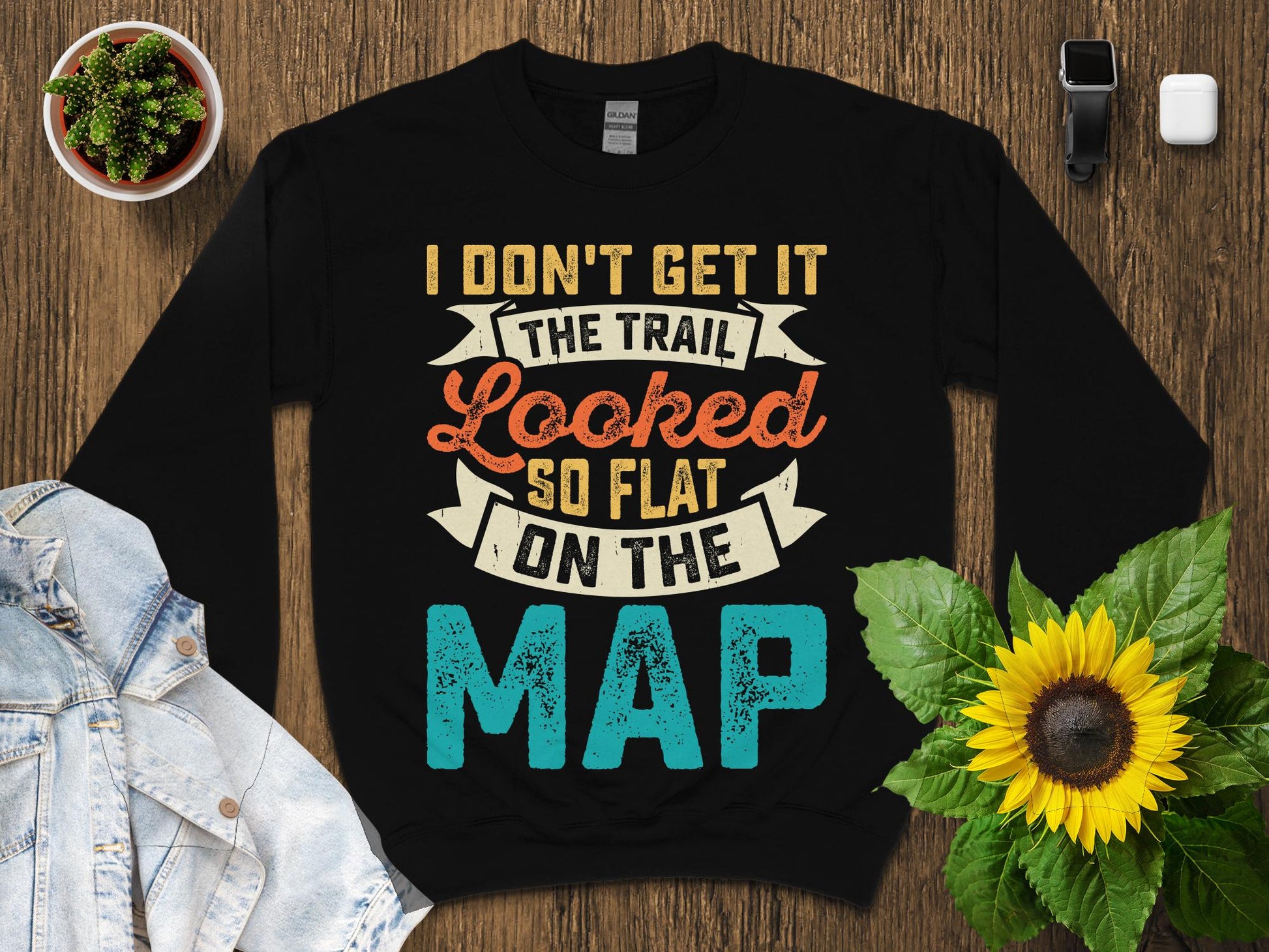 Black sweatshirt with "THE TRAIL LOOKED SO FLAT ON THE MAP" text.