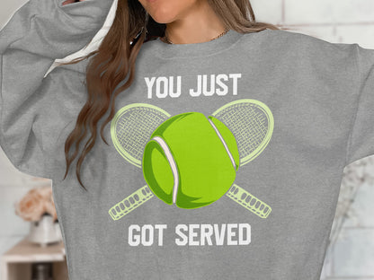 Gray sweatshirt with "YOU JUST GOT SERVED" and tennis ball and rackets graphic.