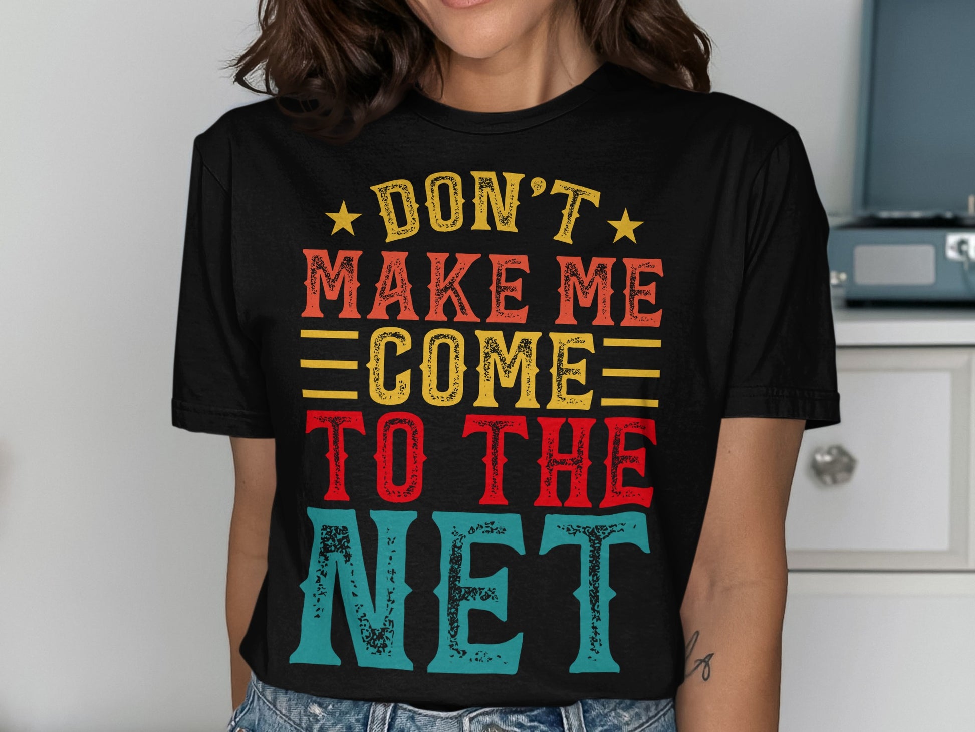 Black t-shirt with bold text: "DON'T MAKE ME COME TO THE NET".