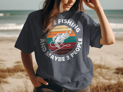 Dark t-shirt with "I LOVE FISHING AND MAYBE 3 PEOPLE" and a fish graphic.