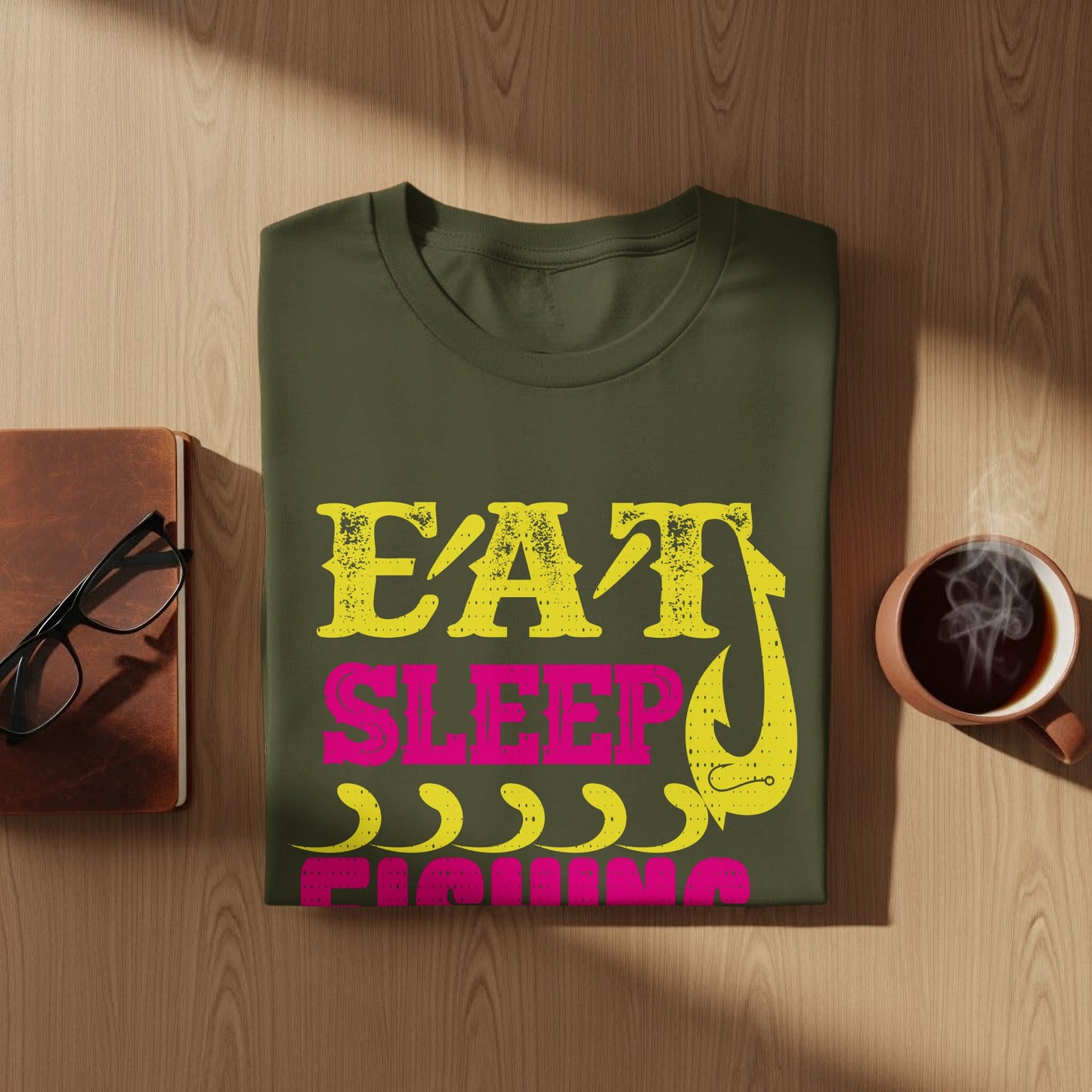 Green t-shirt with "Eat Sleep Fishing" in yellow and pink text and a fishing hook.
