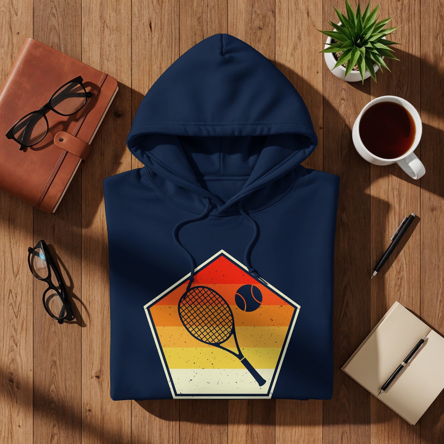 Navy hoodie with a pentagon graphic featuring a tennis racket and ball.