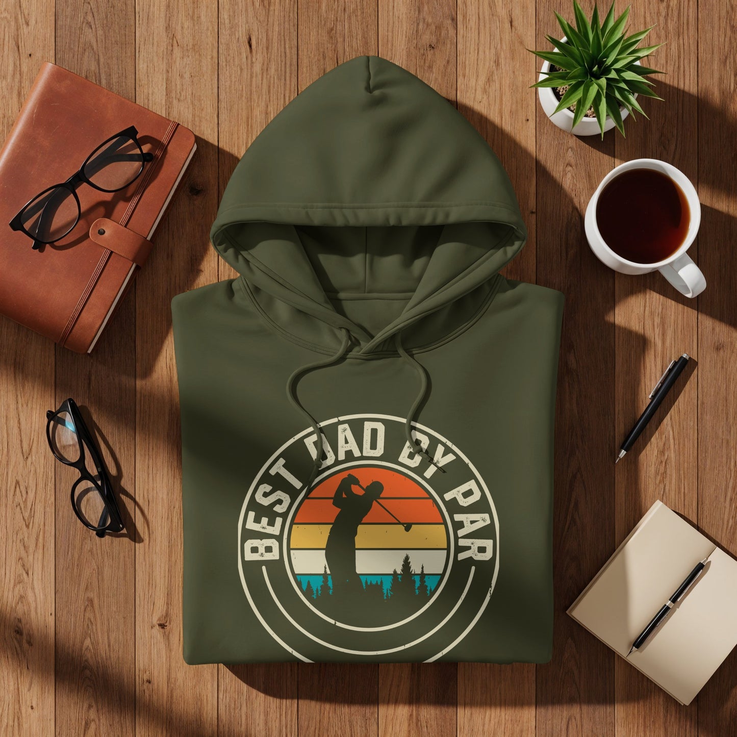 Green hoodie with "Best Dad By Par" text and golf sunset graphic.
