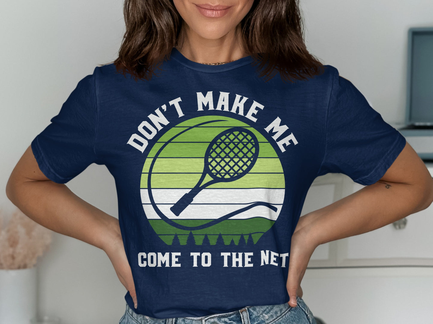 Navy t-shirt with text "DON'T MAKE ME COME TO THE NET" and tennis racket graphic.