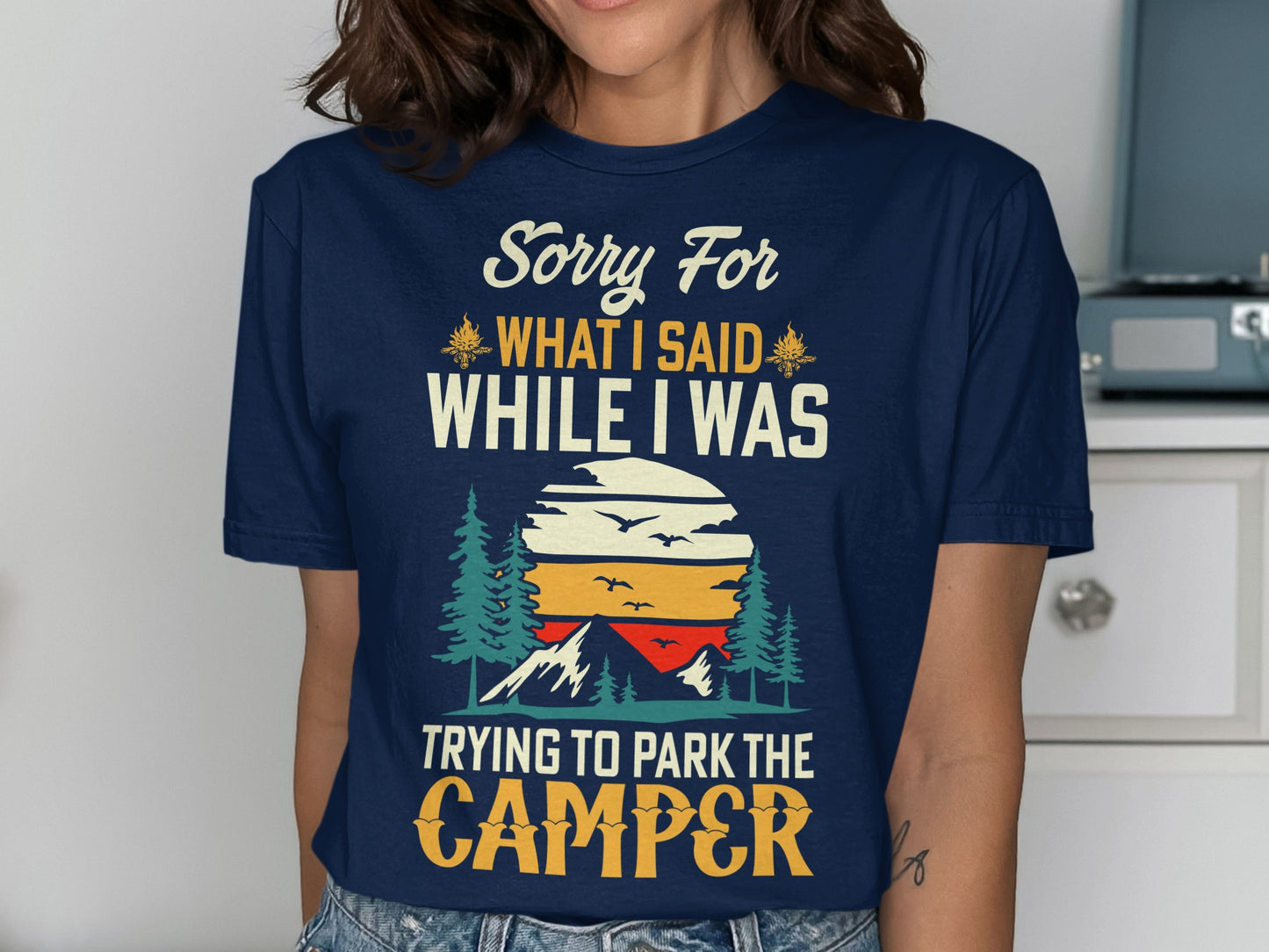 Navy t-shirt with "Sorry For What I Said While I Was Trying to Park the Camper" text and sunset graphic.