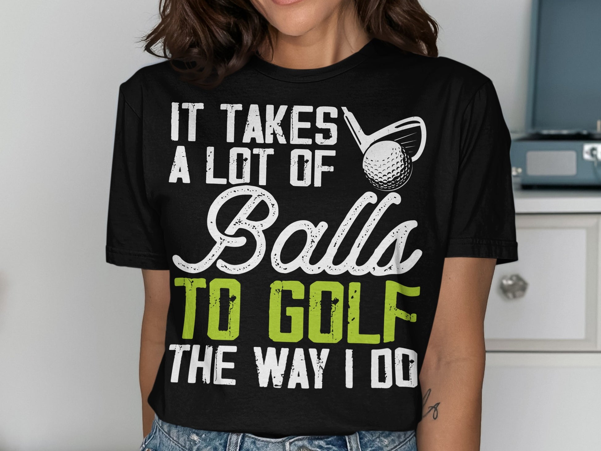 Black t-shirt with "It Takes A Lot of Balls To Golf The Way I Do" text and golf club.