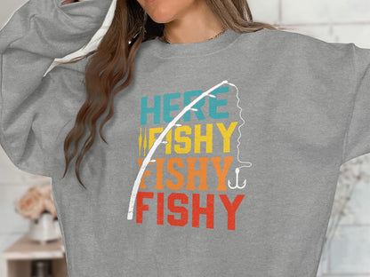 Grey sweatshirt with "Here Fishy Fishy" text and fishing rod graphic.