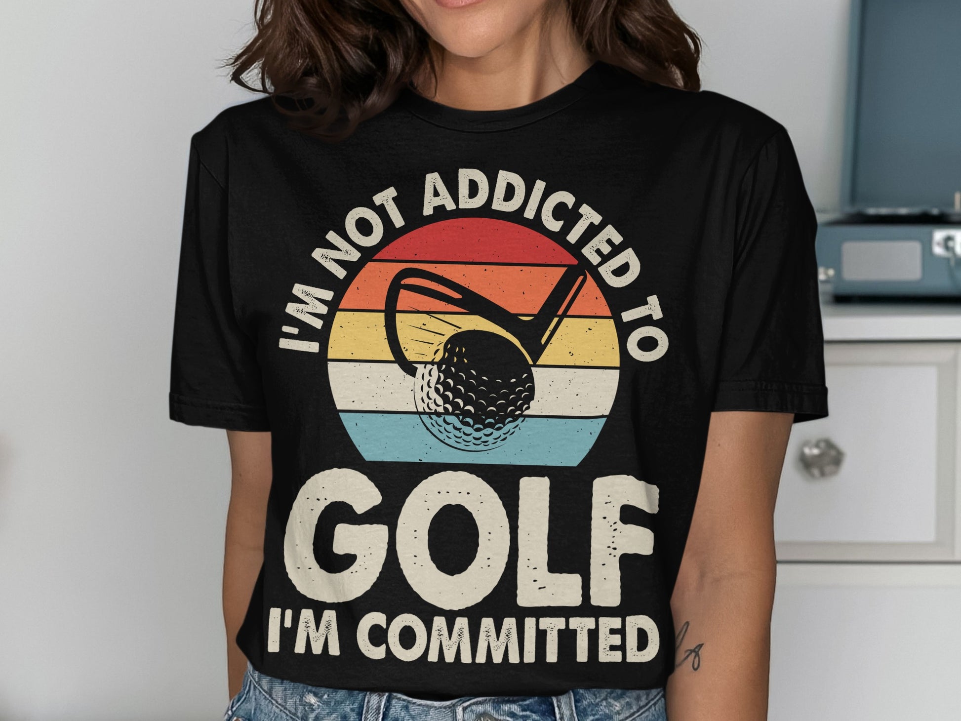 I'm Not Addicted To Golf I'm Committed text on a golf-themed t-shirt.