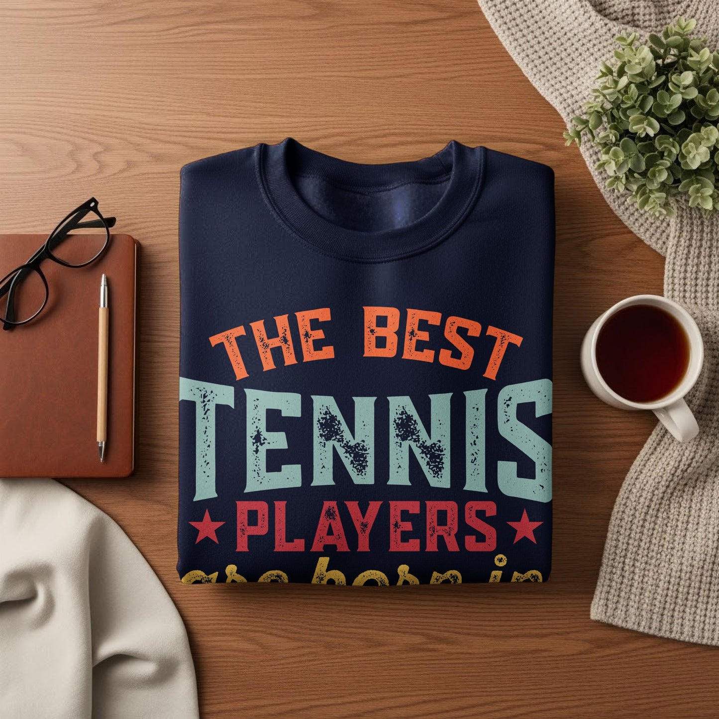 Navy sweatshirt with "THE BEST TENNIS PLAYERS" text and a cup of tea.