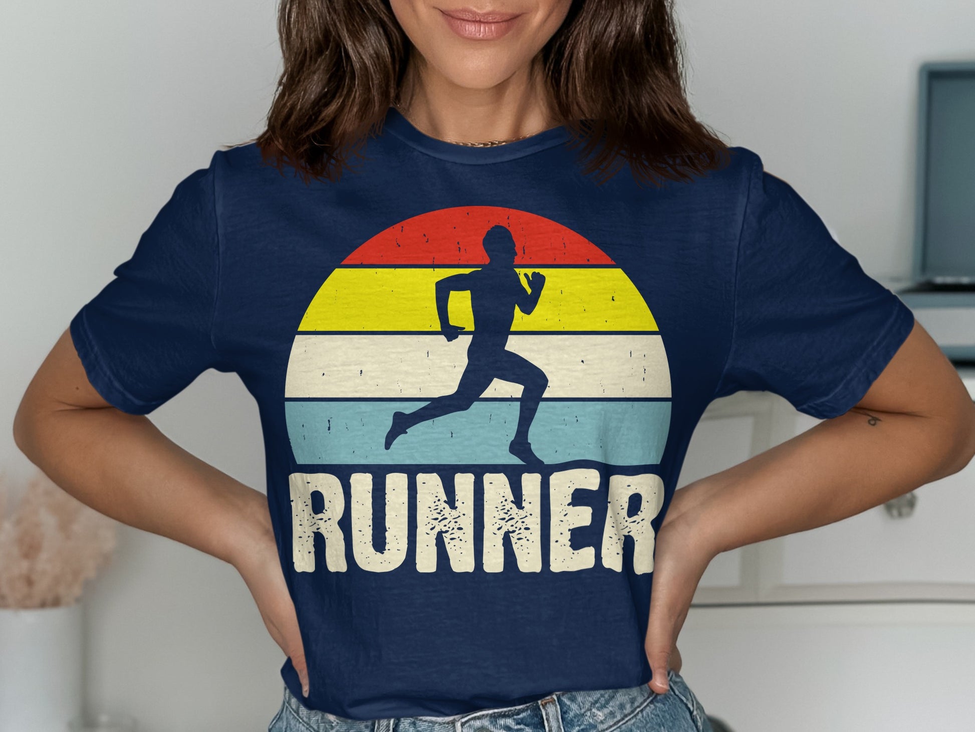 Navy t-shirt with a runner silhouette against a retro striped sunset.