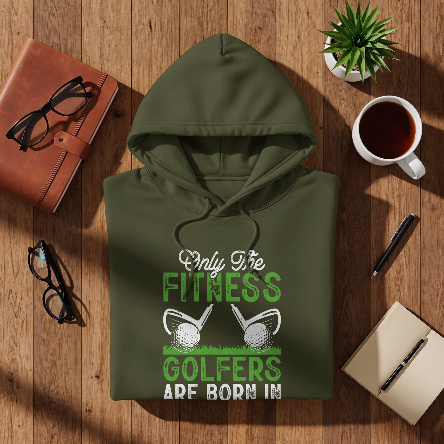 Olive green hoodie with "Only the fittest golfers are born" text.