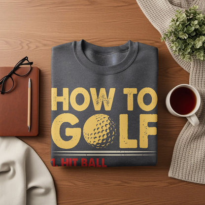 Dark gray sweatshirt with "HOW TO GOLF 1. HIT BALL" in yellow text.