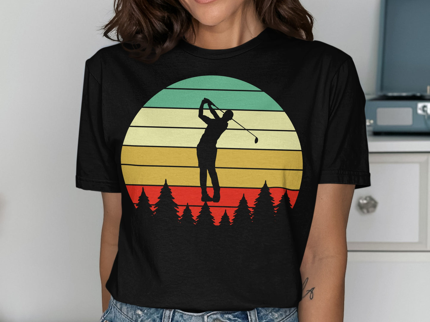 Silhouette of a golfer swinging against a striped sunset over pine trees.