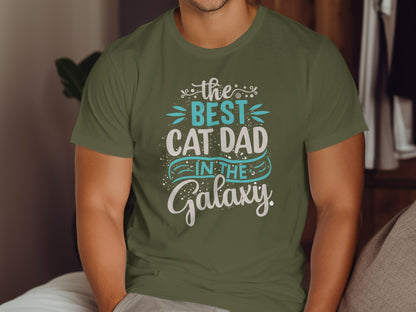 Green t-shirt with "the best cat dad in the galaxy" text.