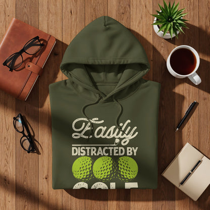 Olive green hoodie with "Easily Distracted By Golf" text and golf balls.