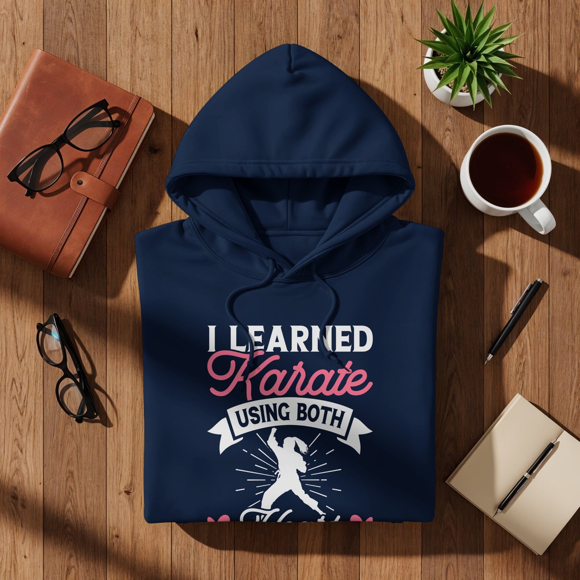 Navy hoodie with white and pink text and graphic about karate.