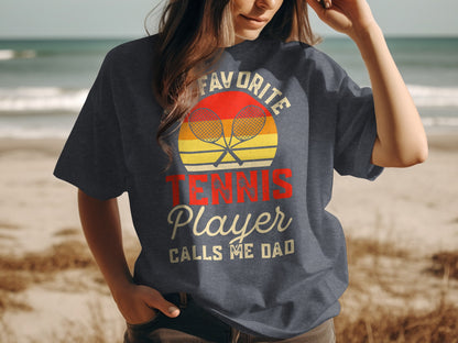 T-shirt with "Favorite Tennis Player Calls Me Dad" and tennis rackets.