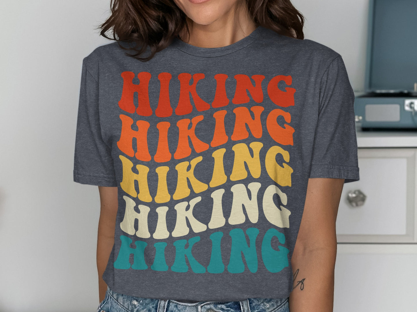 Dark gray t-shirt with "HIKING" in stacked, colorful retro lettering.