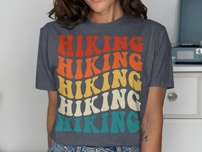 Dark gray t-shirt with "HIKING" in stacked, colorful retro lettering.