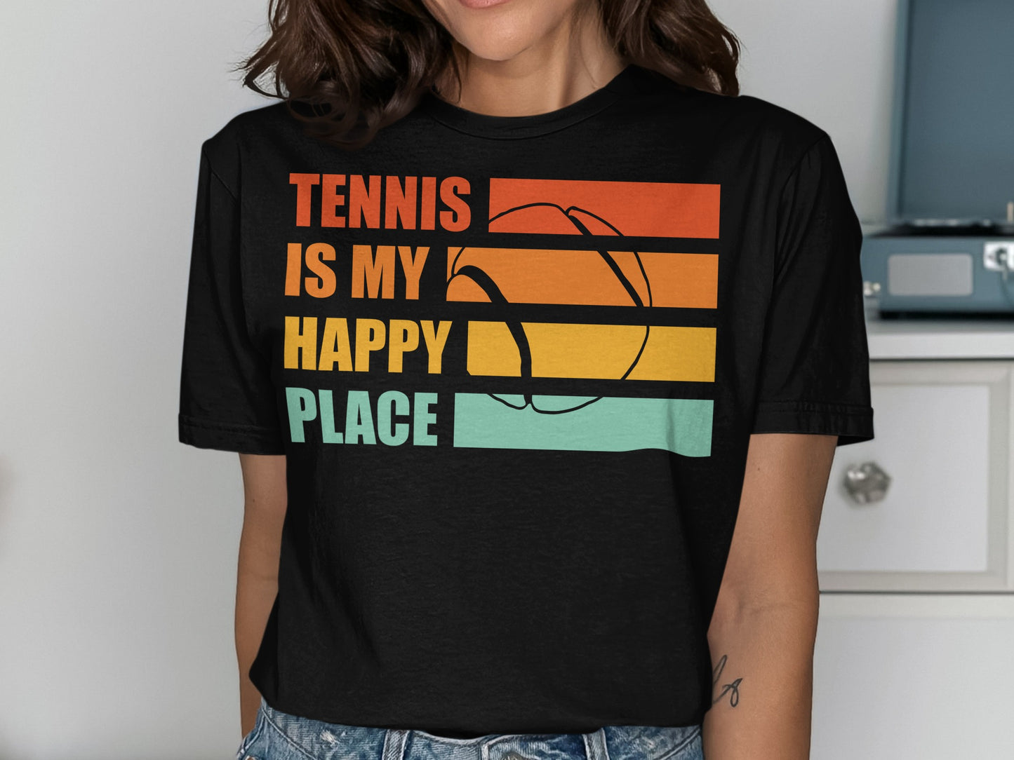 Black t-shirt with "Tennis is my happy place" and a tennis ball graphic.