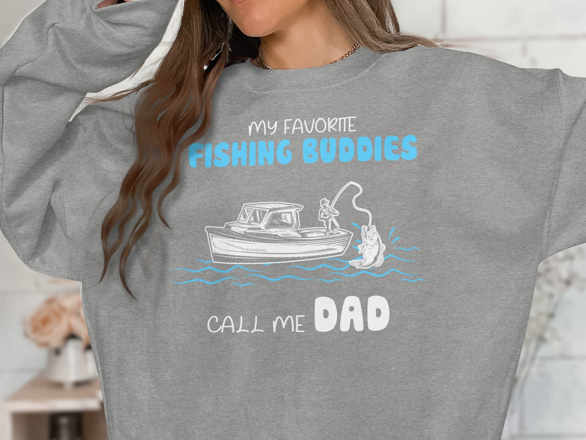 Gray sweatshirt with "My Favorite Fishing Buddies Call Me Dad" text and fishing graphic.