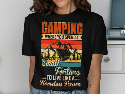Black t-shirt with "Camping where you spend a small fortune to live like a homeless person" text and graphic.