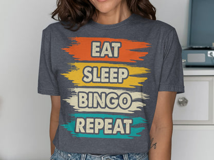 Dark grey t-shirt with "EAT SLEEP BINGO REPEAT" in colorful brush strokes.
