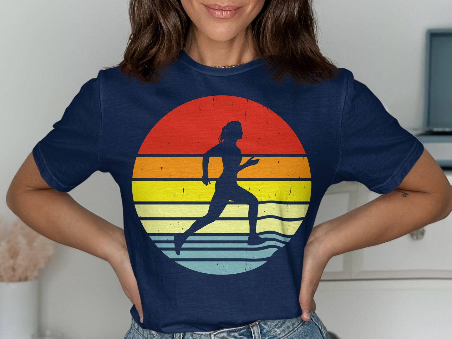 Navy t-shirt with a runner silhouette against a colorful retro sunset graphic.