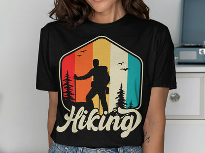 Black t-shirt with hiker silhouette against colorful mountain stripe and "Hiking" text.