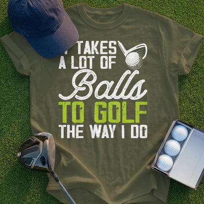 Olive green t-shirt with white and green text: "Takes a lot of balls to golf the way I do".