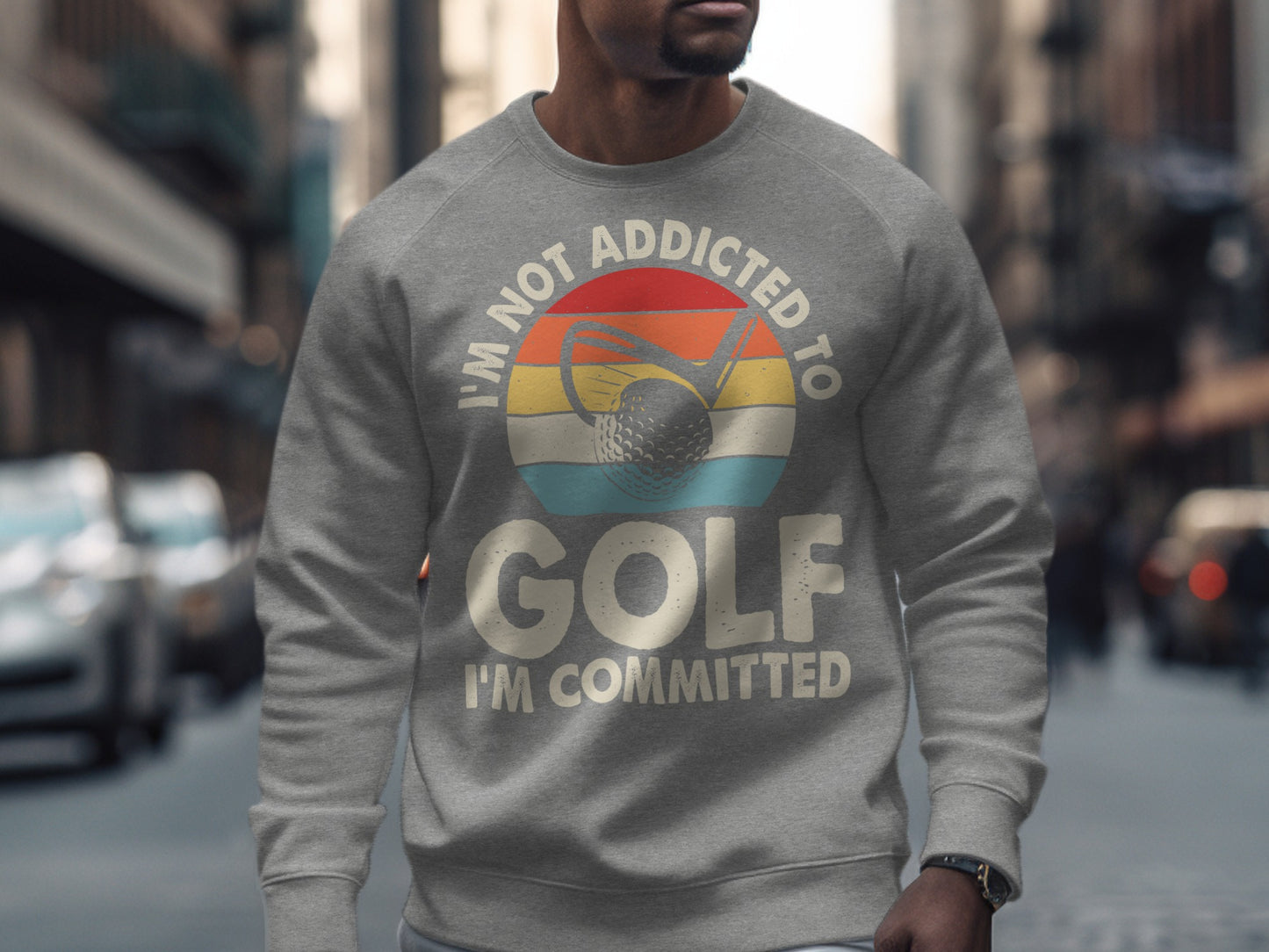 Gray sweatshirt with "I'm not addicted to golf, I'm committed" text and golf ball graphic.