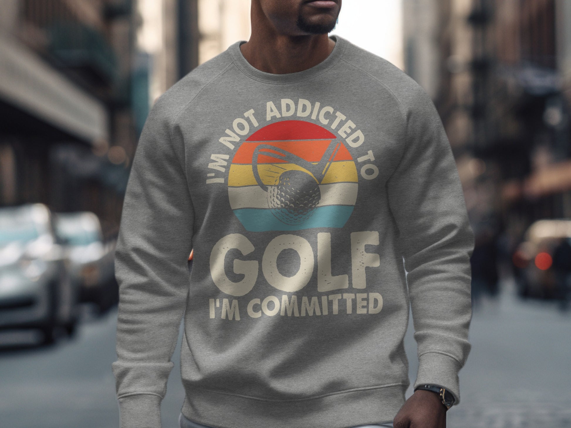 Gray sweatshirt with "I'm not addicted to golf, I'm committed" text and golf ball graphic.