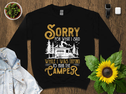 Black sweatshirt with "Sorry for what I said while I was trying to park the camper" text.
