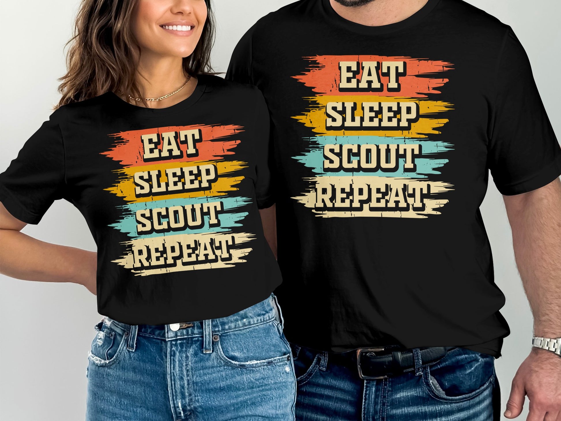T-shirts with "Eat Sleep Scout Repeat" text in colorful, distressed stripes.