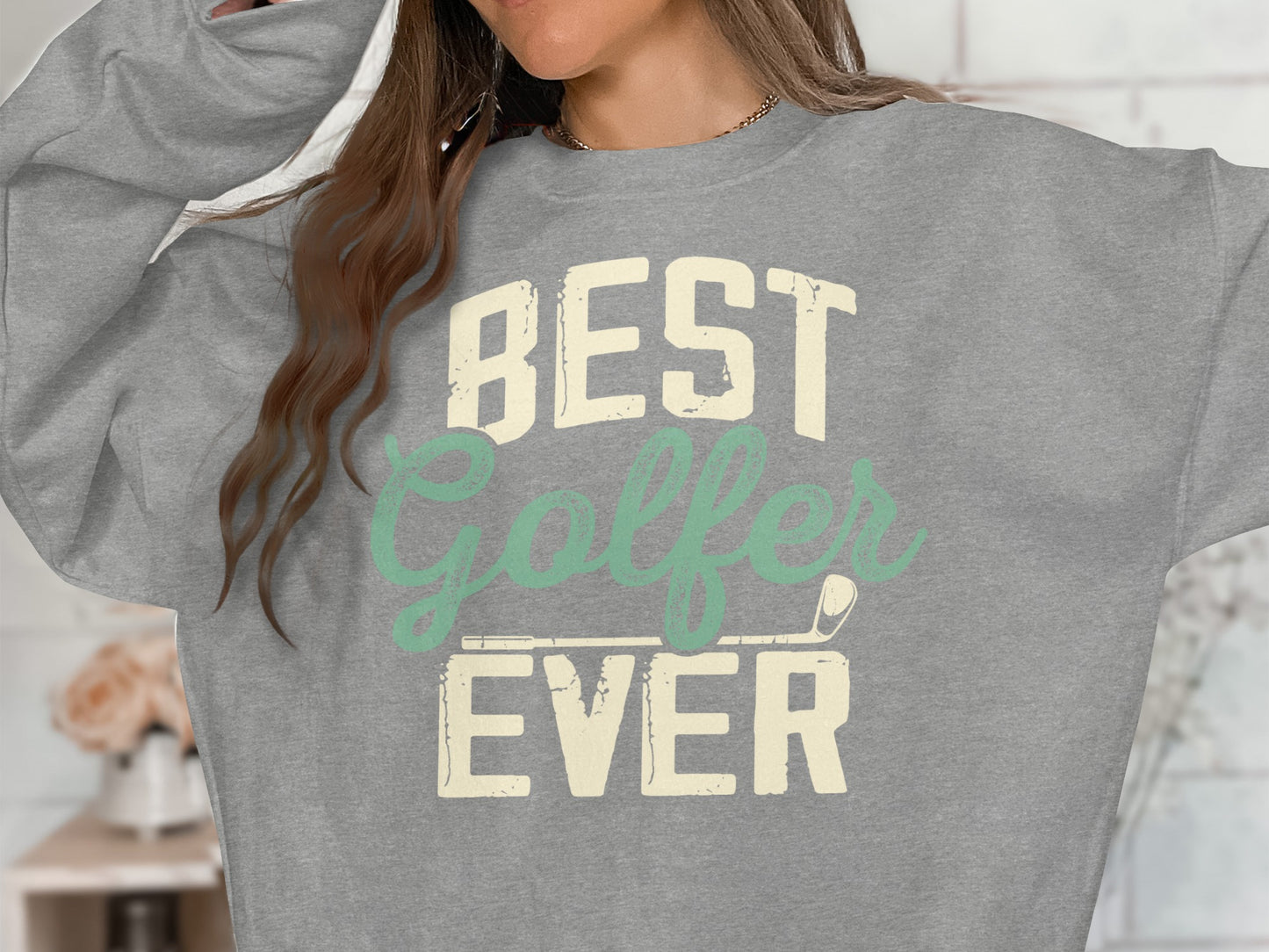Gray sweatshirt with "BEST Golfer EVER" text and golf club graphic.