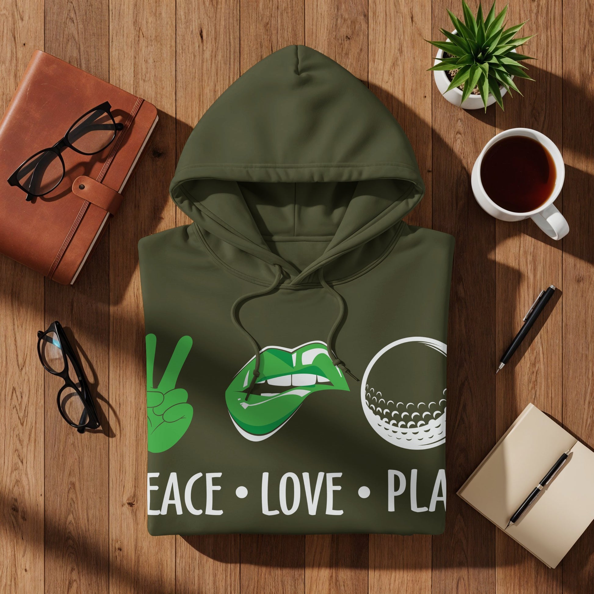Green hoodie with "PEACE LOVE PLA" text, peace sign, lips, and golf ball.
