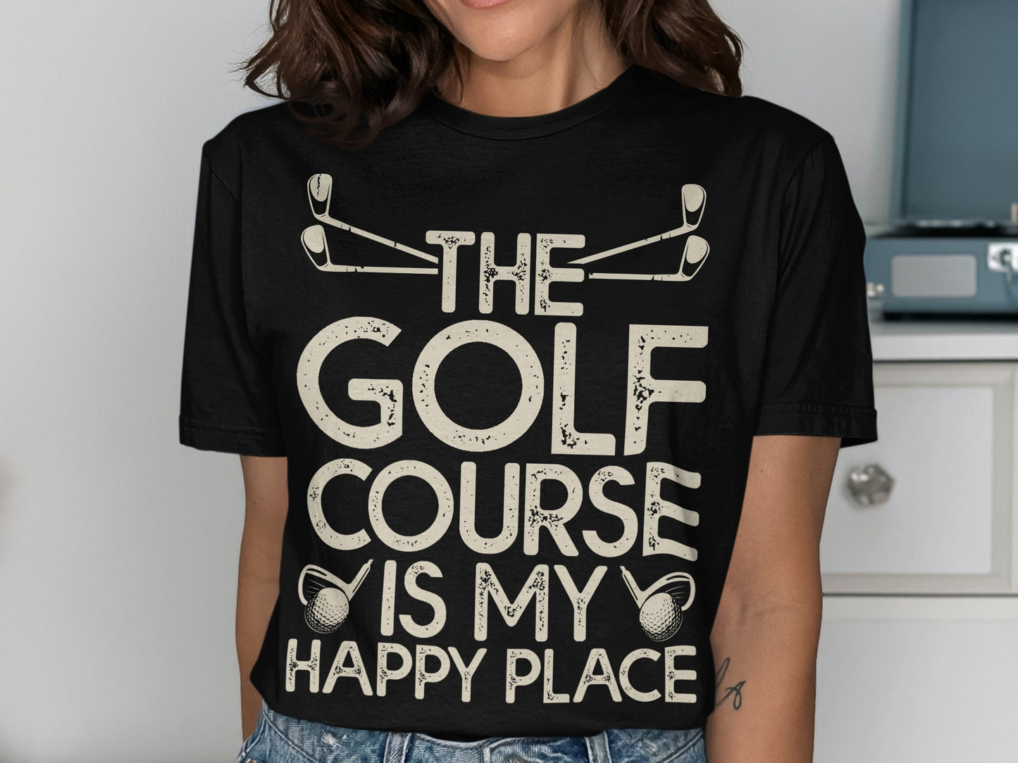 Black t-shirt with "The Golf Course Is My Happy Place" text and golf club graphics.