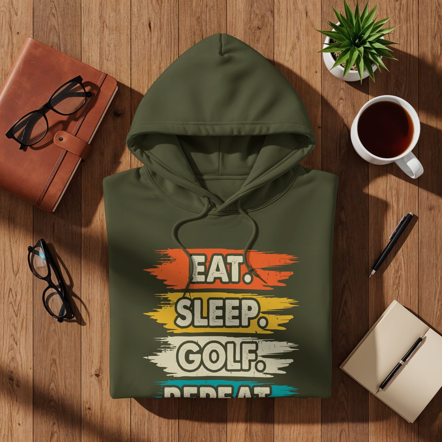 Olive green hoodie with "Eat. Sleep. Golf. Repeat." text design.