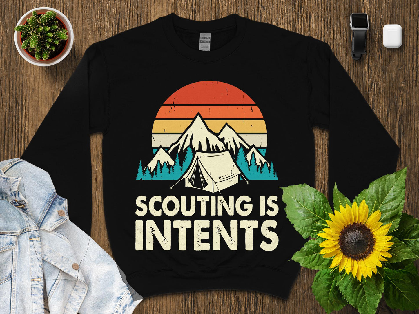 Black sweatshirt with "Scouting Is Intents" text and mountain tent graphic.