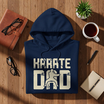 Navy hoodie with "KARATE DAD" graphic on wooden surface.