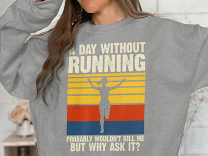 Grey sweatshirt with vintage "A day without running probably wouldn't kill me? But why ask it?" text.
