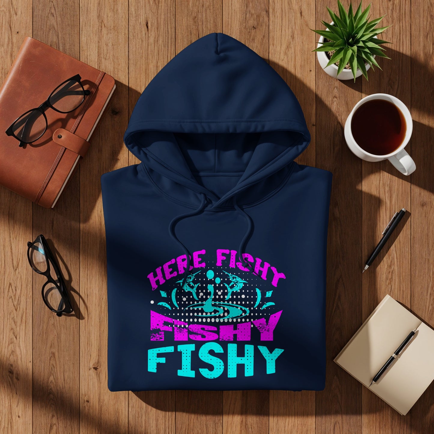 Navy hoodie with "HERE FISHY FISHY" text in neon pink and blue lettering.