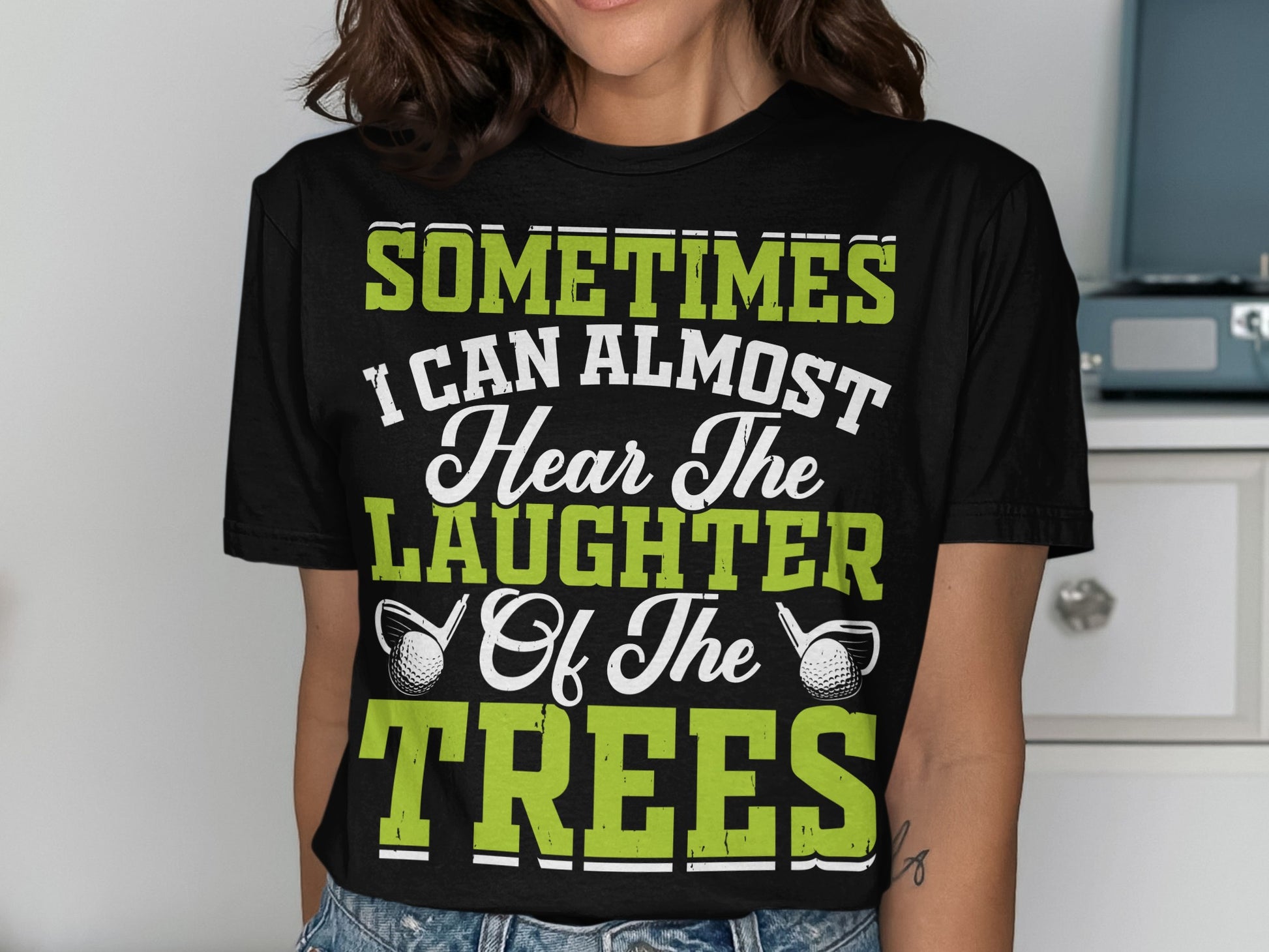 Black t-shirt with green text: "Sometimes I Can Almost Hear The Laughter Of The Trees".