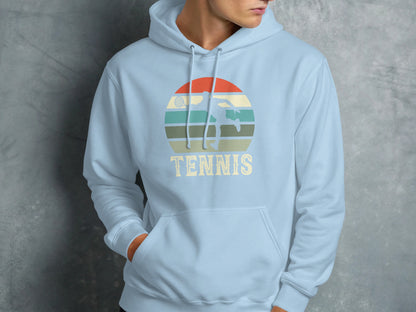 Light blue hoodie with retro tennis graphic featuring a player and sunset.